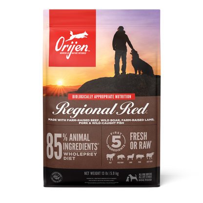 Orijen Regional Red dog food package with a silhouette of a person and dog on a mountain at sunset.
