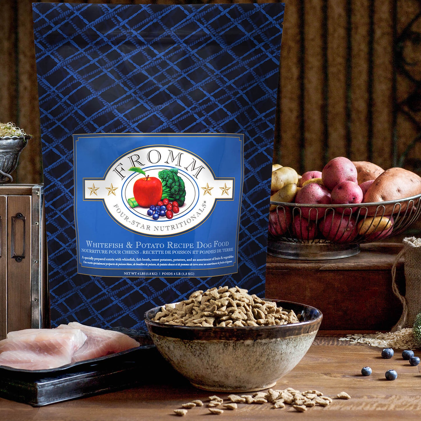 Fromm pet food package with a bowl of dog food on a wooden surface.
