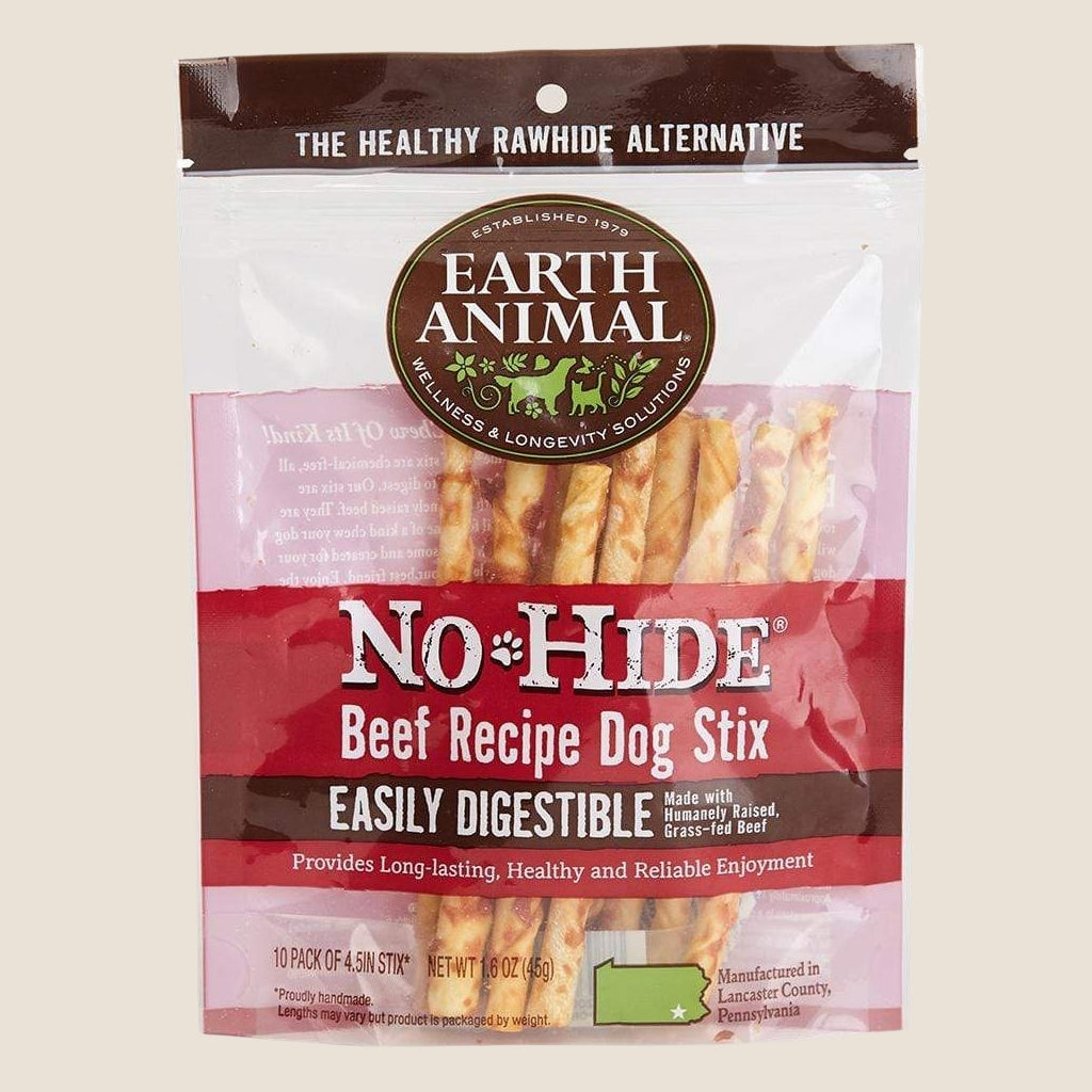 Package of Earth Animal No-Hide Beef Recipe Dog Stix on a beige background